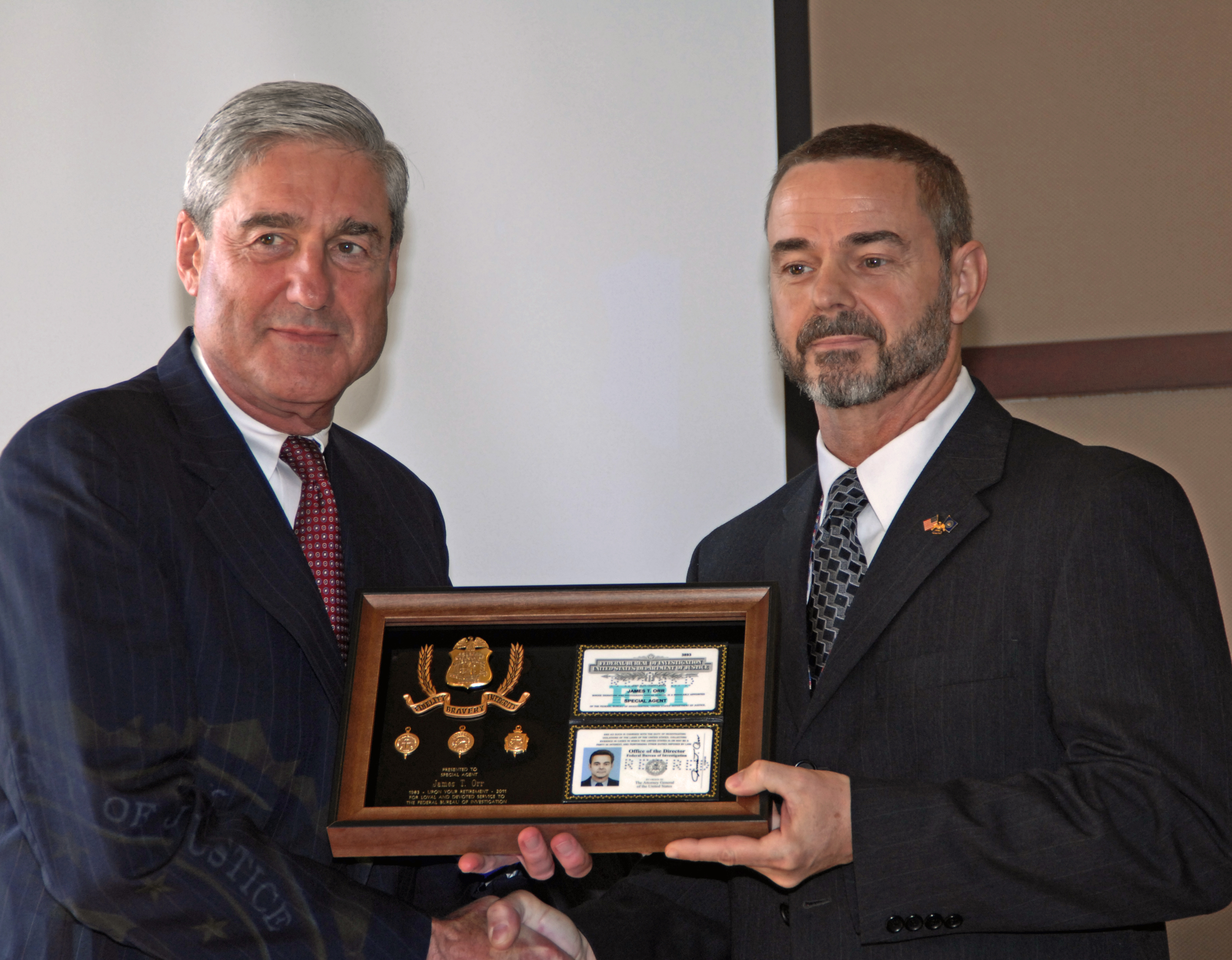 James T. Orr receiving his retirement credentials from FBI Director Robert Mueller